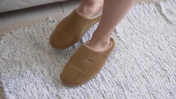Close-up of the legs, the woman removes the warm slippers from her feet and goes to bed. - Footage, Video