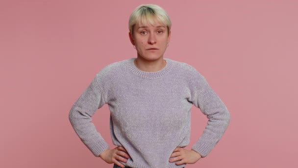 Displeased upset woman reacting to unpleasant awful idea, dissatisfied with bad quality, wave hand, shake head No, dismiss idea, dont like proposal. Girl on pink studio background. Lgbt gay lesbian - Footage, Video