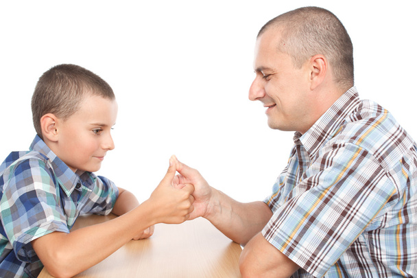 Father and son thumb wrestling - Фото, изображение