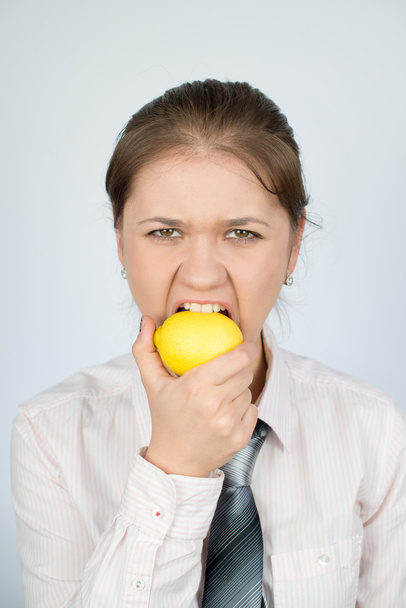 business woman eating a lemon - Fotó, kép