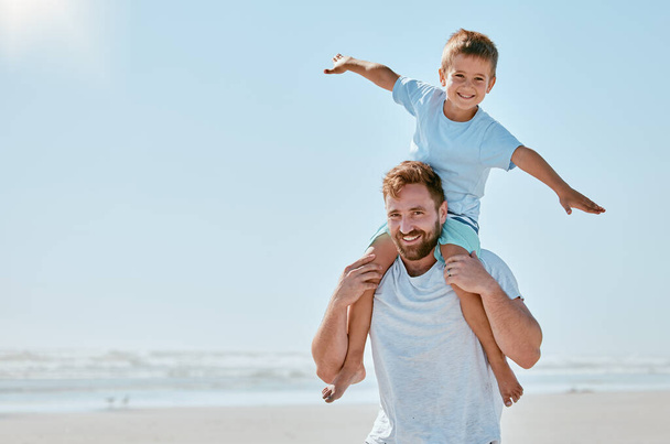 Father, kid and piggy back at beach on vacation, holiday or trip mock up. Family love, care and portrait of man bonding with boy while carrying him on shoulders, having fun and enjoying time together. - Photo, Image