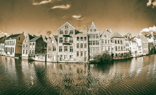 View of Graslei quay and Leie river in the historic city center in Gent, Belgium. Architecture and landmark of Ghent in spring season - Photo, Image