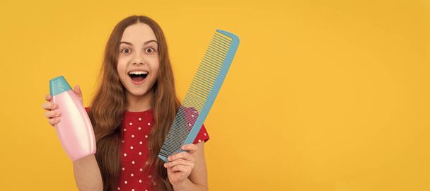 amazed teen girl has long hair hold hair brush and lotion. Kid girl hair care, horizontal poster. Banner header with copy space - Photo, image