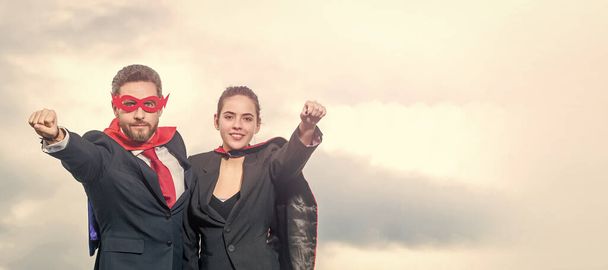 smiling business couple in superhero suit on sky background. Horizontal poster design. Web banner header, copy space - Foto, Imagem