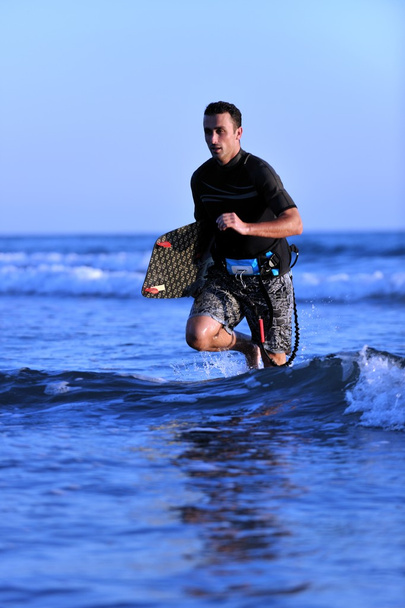 Portrait of a young kitsurf man at beach on sunset - Zdjęcie, obraz
