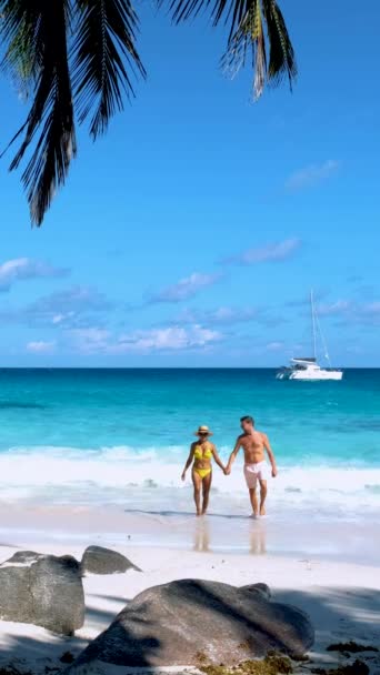 Couple of men and women on the beach of Anse Lazio beach at Praslin island Seychelles - Footage, Video