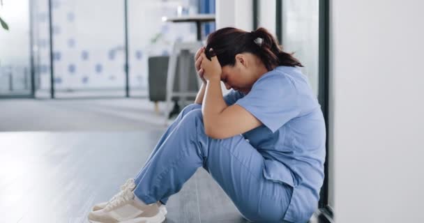 Nurse, depression and stress on hospital floor for patient loss, surgery fail or virus death rate in wellness, medical or community clinic. Mental health, sad and anxiety for healthcare worker woman. - Footage, Video
