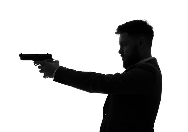 Silhueta de jovem com arma sobre fundo branco - Foto, Imagem