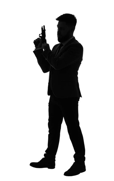 Silhouette of young man with gun on white background - Photo, Image