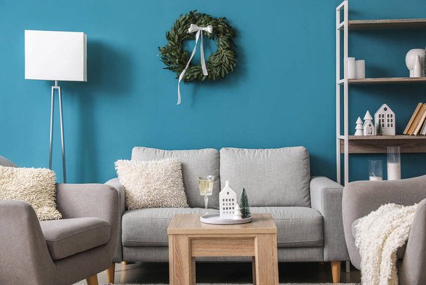 Interior de la sala de estar con corona de Navidad, sofá y sillones - Foto, Imagen