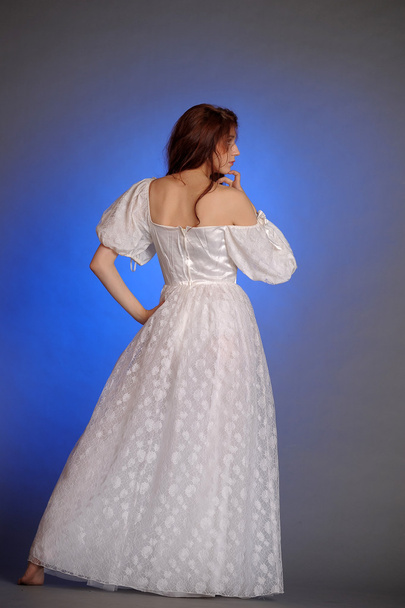 Beautiful Young Woman in a white dress. In the studio. - Фото, зображення