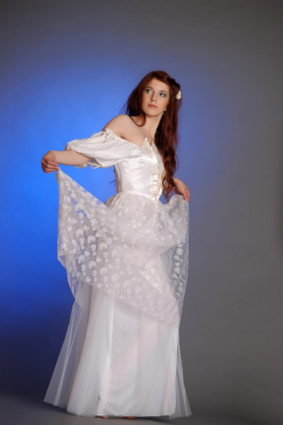 Beautiful Young Woman in a white dress. In the studio. - Foto, imagen