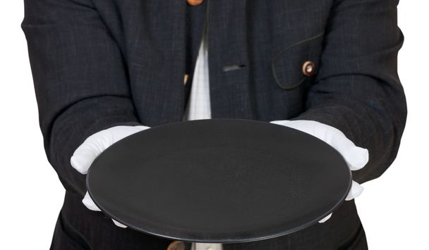 direct view of empty black plate in hand in gloves - Photo, Image