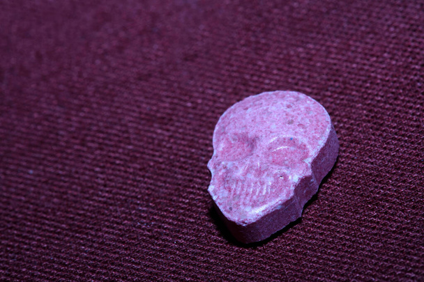 Pink skull ecstasy pill close up background high quality prints purple army dope narcotics substance high dose psychedelic way of life - Photo, Image
