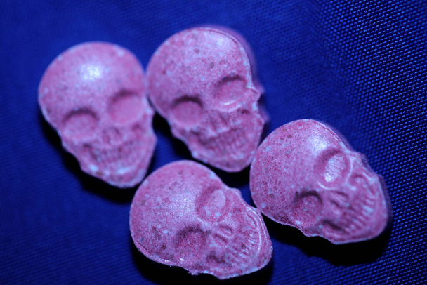 Pink skull ecstasy pill close up background high quality prints purple army dope narcotics substance high dose psychedelic way of life - Photo, Image