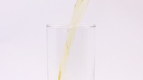 Juice pouring into a glass - Filmati, video