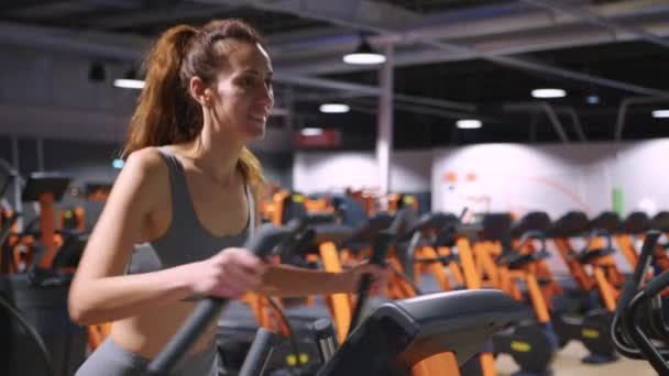 A modern, advanced woman performs sports exercises in the gym to maintain a beautiful body shape and health. Sports training and healthy lifestyle. Sport lifestyle concept. High quality 4k footage - Footage, Video