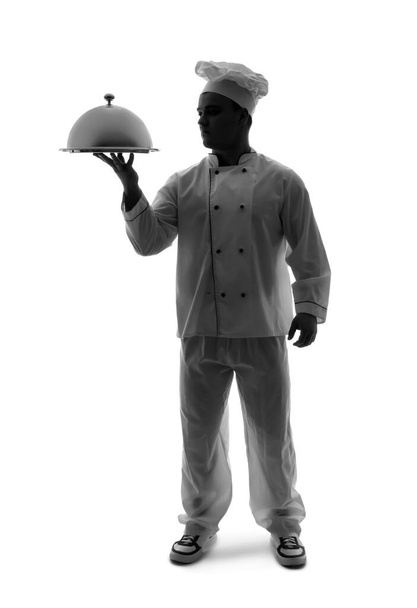 Silhouette de chef masculin avec cloche sur fond blanc - Photo, image