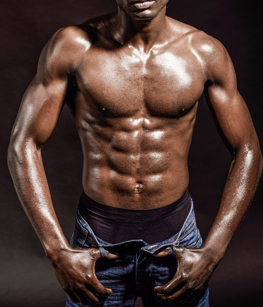 Athletic black man on black background - Valokuva, kuva