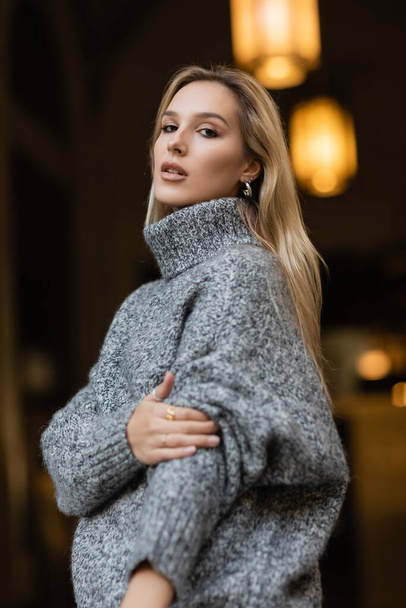 portrait of young woman in grey sweater looking at camera in New York  - Photo, Image