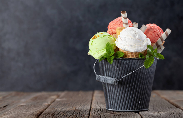 Various ice cream in waffle cones. Strawberry, pistachio and vanilla icecream. With copy space - Photo, Image