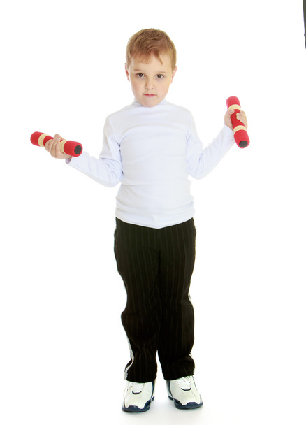 Little boy with dumbbells in his hands. - Foto, imagen