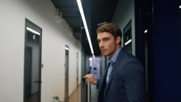 Closeup employee going office corridor. Businessman leaving conference room finishing work. Confident handsome executive walking empty hallway after interview corporate meeting. Success career concept - Footage, Video