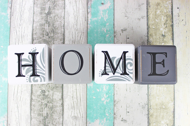 Home sign on a distressed wooden background with turquoise tones - Photo, Image