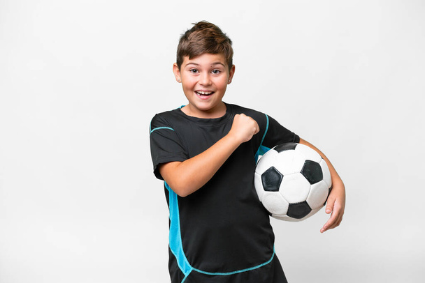 Little caucasian football player kid over isolated white background celebrating a victory - Foto, Imagen