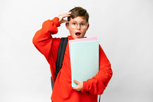 Little caucasian student kid over isolated background with surprise expression - Photo, Image