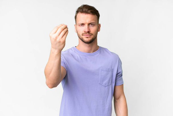 Young handsome caucasian man over isolated white background making Italian gesture - Zdjęcie, obraz