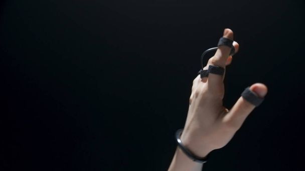 Closeup haptic sensor hands touching metaverse. Unrecognizable person trying virtual reality videogame. Anonymous user exploring social media platform black background. Technology era next generation  - Photo, Image