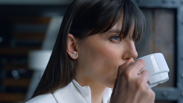 Melancholic businesswoman drinking tea resting in luxury interior closeup. Leader person enjoying coffee and relax hotel vacation. Thinking woman tasting hot beverage. Confident ceo relax after work  - Фото, изображение