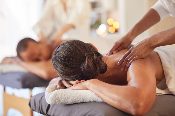Massage, relax and peace with couple in spa for healing, health and zen treatment. Detox, skincare and beauty with hands of massage therapist on man and woman for calm, physical therapy and luxury. - Photo, Image