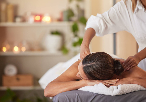 Massage, relax and peace with woman in spa for healing, health and zen treatment. Detox, skincare and beauty with hands of massage therapist on customer for calm, physical therapy or luxury in salon. - Photo, Image