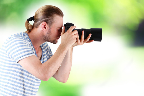 Young photographer taking photos outdoors - Fotó, kép