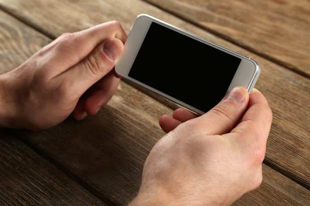 Hands holding smart mobile phone - Foto, imagen