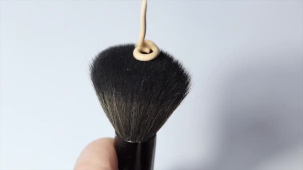 pouring concealer on makeup brush on white background. slow motion - Footage, Video