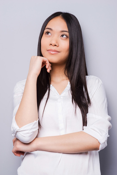 Thoughtful young asian woman - Фото, изображение