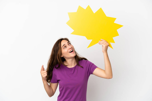 Young caucasian woman isolated on white background holding an empty speech bubble and thinking - Fotografie, Obrázek