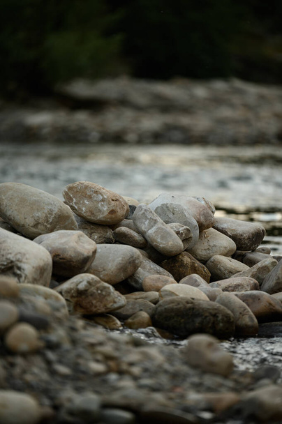 Coastal stones near the water, a place for copy space, large stones on the river bank. - Photo, Image