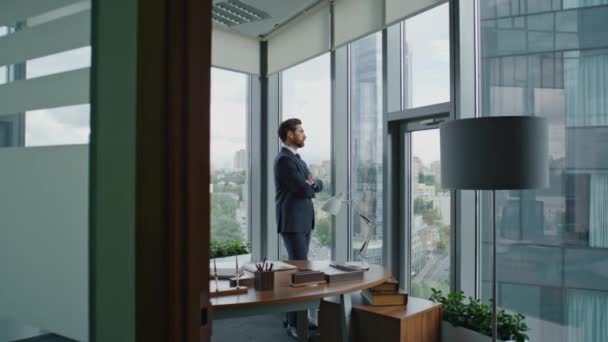 Busy confident lawyer thinking about work case standing in modern office wearing elegant suit. Serious bearded businessman taking break looking window. Pensive manager contemplating business develop. - Footage, Video