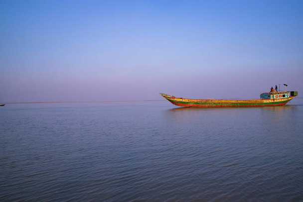 Landscape View of a small cargo ship against a blue sky on the  Padma river Bangladesh - Foto, Imagem
