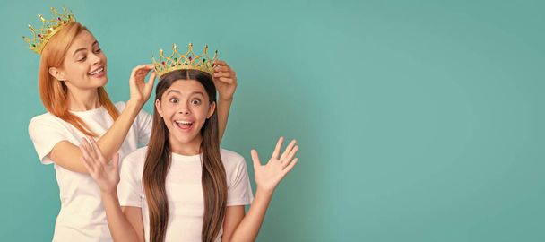 Mother and daughter child banner, copy space, isolated background. This is a happy surprise. Surprised child win crown. Happy mother crown daughter. Pageant girl - 写真・画像