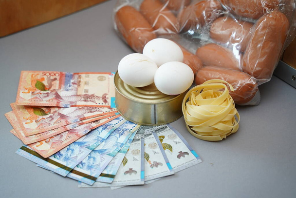 Almaty, Kazahsztán - 10.04.2022: Kazahsztáni tenge különböző élelmiszeripari termékei és bankjegyei kerülnek az asztalra. - Fotó, kép