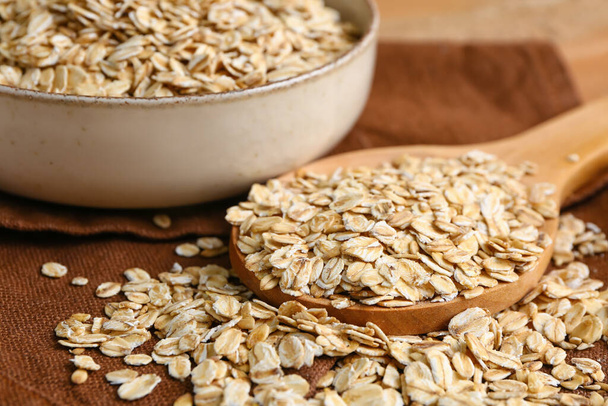 Wooden spoon with raw oatmeal, closeup - Photo, Image