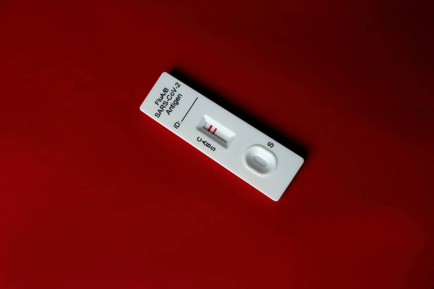 Flu A test kit, influenza A positive isolated on red background - Photo, Image