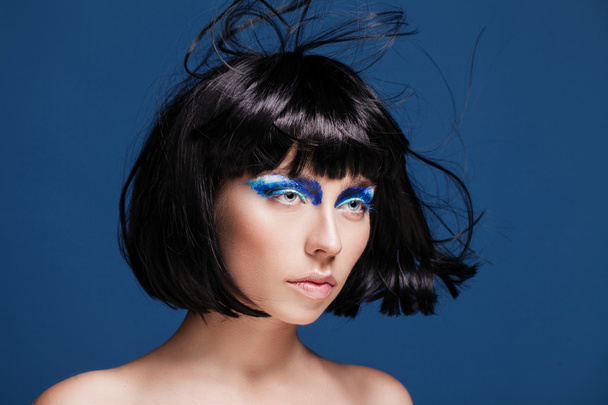closeup beauty shot of young caucasian brunette with blue eyeshadows - Fotoğraf, Görsel