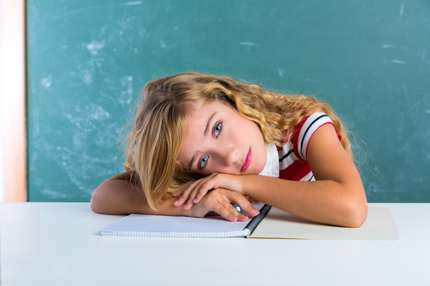 Boring sad expression student schoolgirl on desk - Photo, image