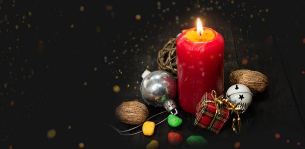 Christmas red candlelight with decoration ornament on dark banner with copy space. - Photo, Image